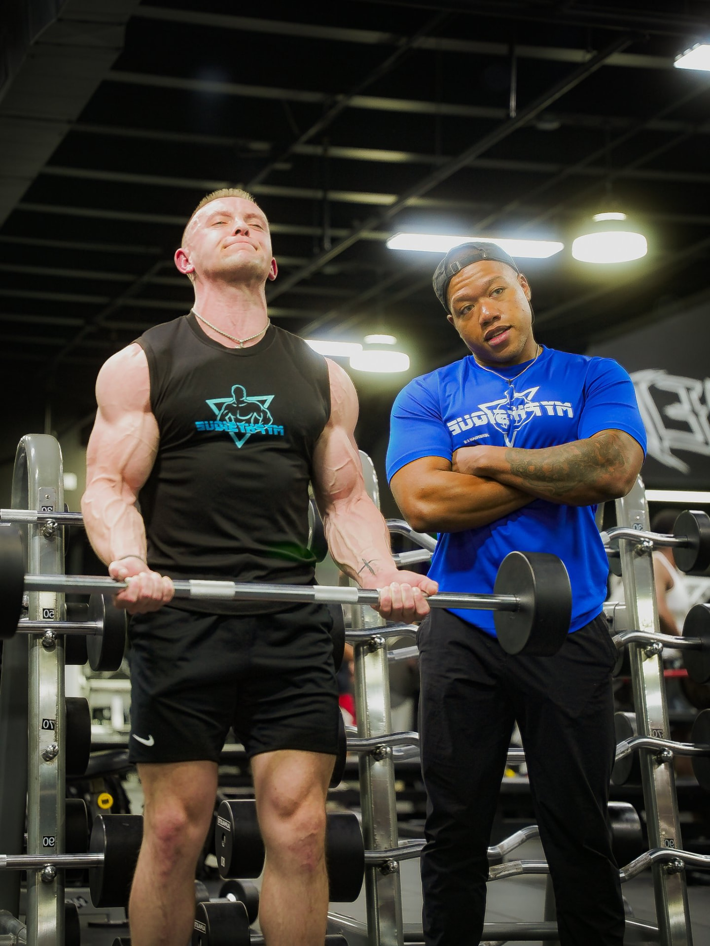 Coach Daylen coaching a client through a barbell curl session